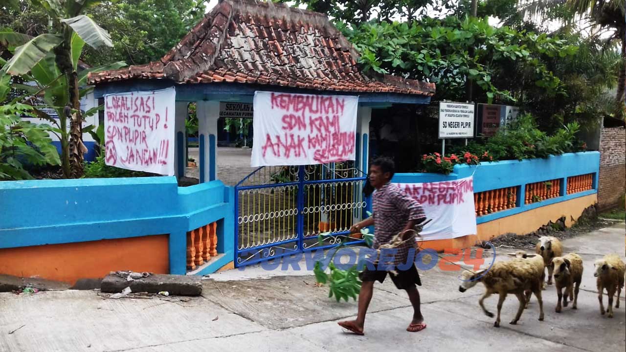 Seorang warga melintas di depan SD Plipir
