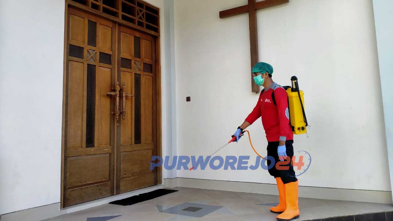 Seorang relawan PMI Puworjeo melakukan penyemprotan di rumah ibadah jelang perayaan Natal.