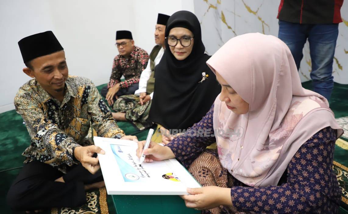 Bupati Purworejo saat menulis pesan dan kesan terhadap Masjid Al Fatih Purwodadi